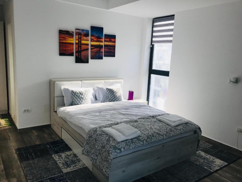 a bedroom with a bed with two paintings on the wall at Studio for 2 in Mamaia Summerland in Mamaia