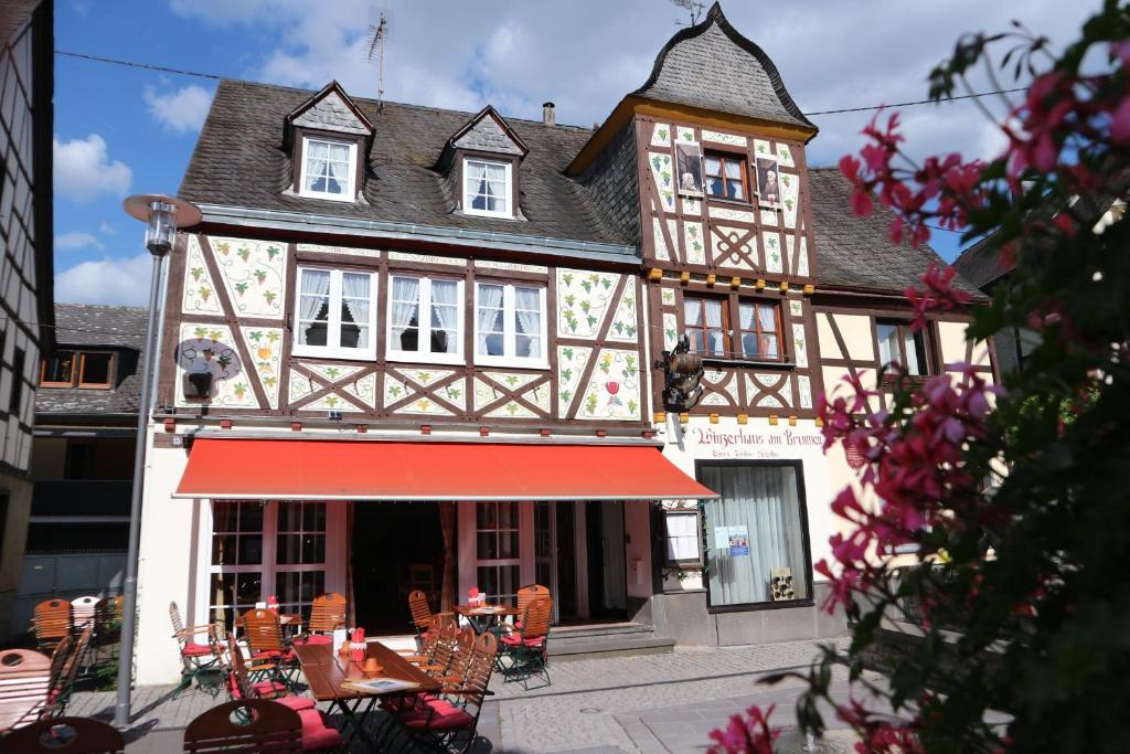 a building with a red awning in front of it at Winzerhäuschen am Brunnen in Kobern-Gondorf