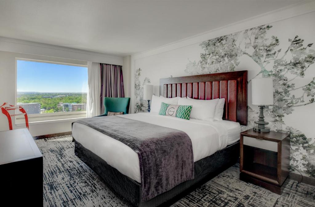 a hotel room with a large bed and a window at The Grove Hotel in Boise