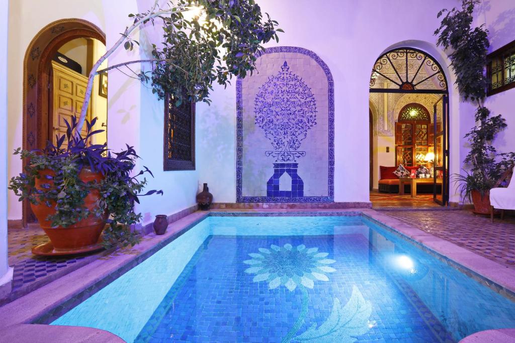 a house with a swimming pool in a room at Riad Daria Suites & Spa in Marrakesh