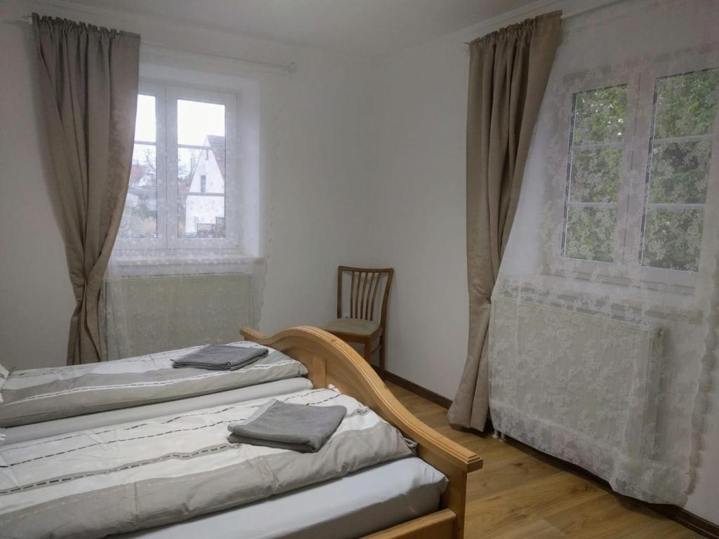 a bedroom with two beds and a window at Old Bavarian House on the Romantic Road in Harburg