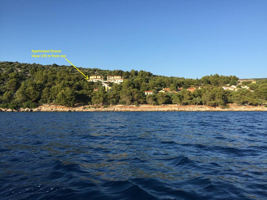 a large body of water with a house in the background at Dream View apartment in Cres