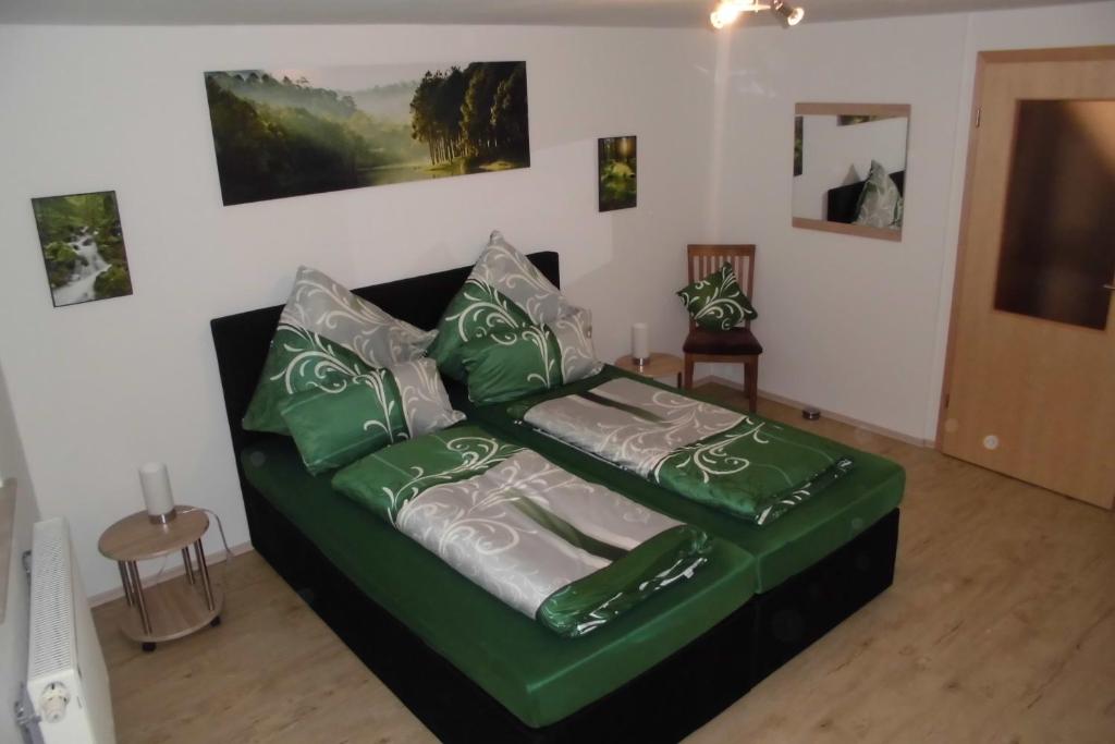 a green couch sitting in a living room at Gasthaus Beyersdorfer in Rieth