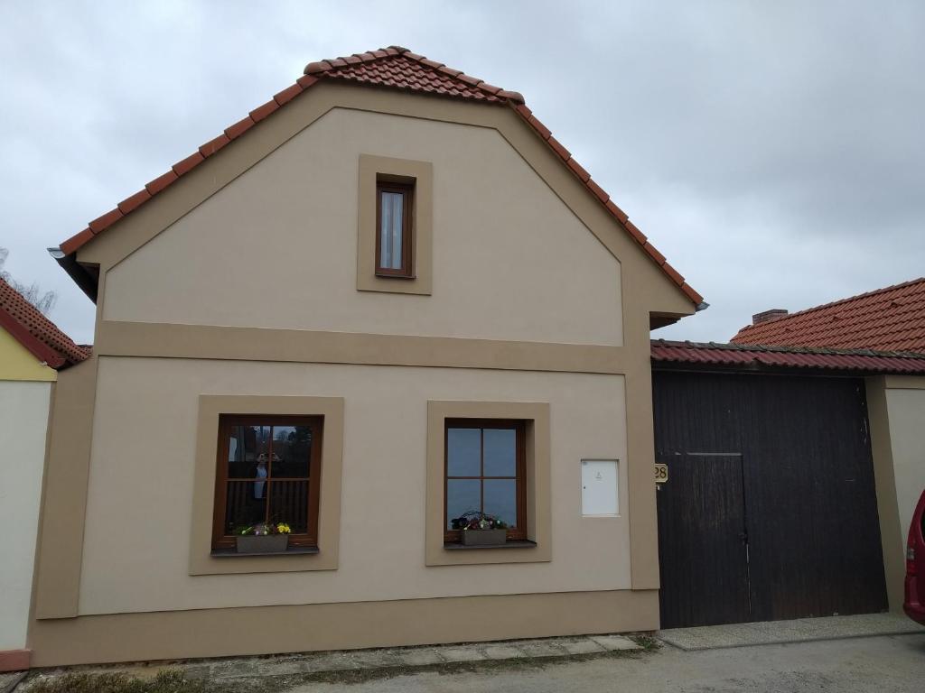 una casa con dos ventanas y un garaje en Apartmán na statku, en Klec