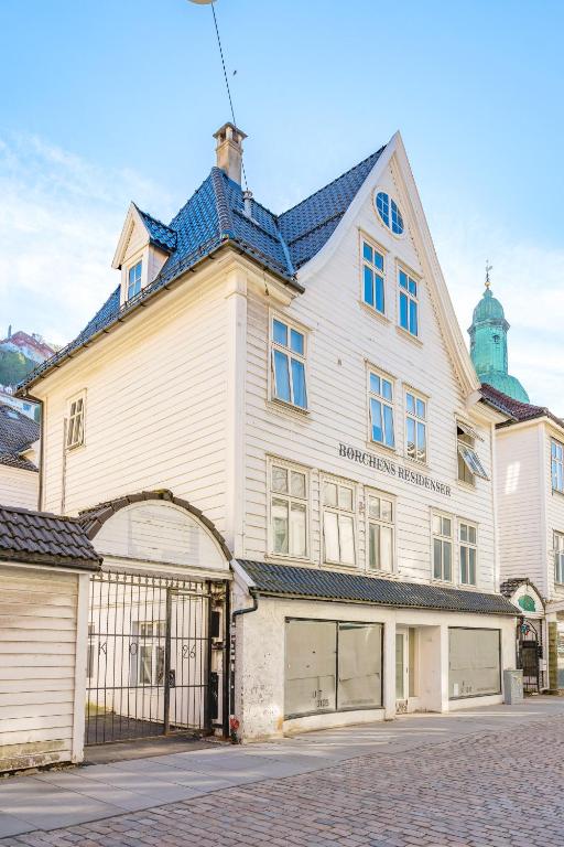 ein großes weißes Gebäude mit einem Tor davor in der Unterkunft Fabryka in Bergen
