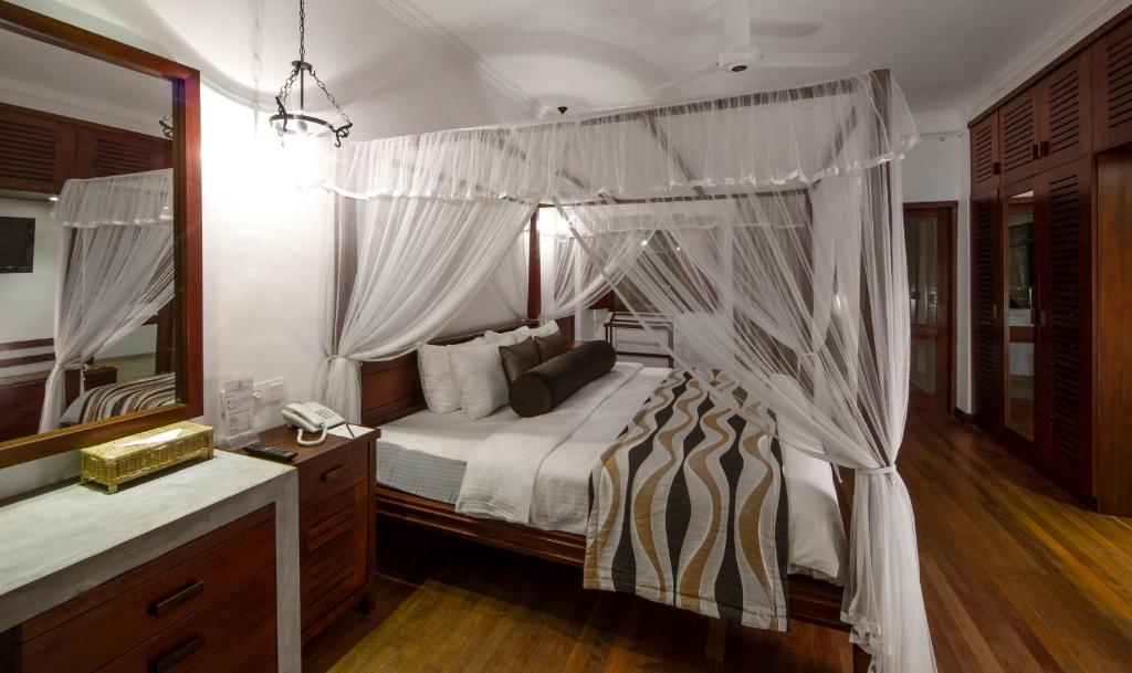 Postel nebo postele na pokoji v ubytování Tangerine Beach Hotel