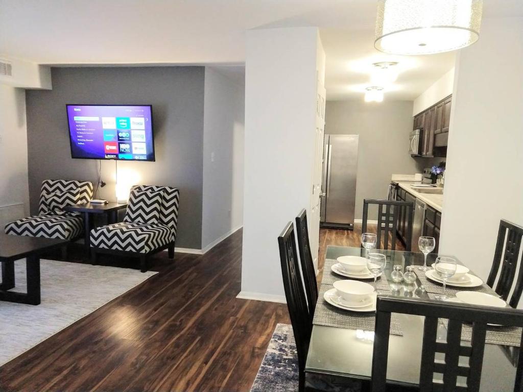 a dining room and living room with a dining table at Desirable Condo in Central Raleigh in Raleigh