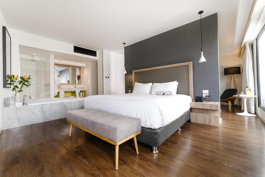 a bedroom with a large bed and a bath tub at INNSiDE by Meliá Lima Miraflores in Lima