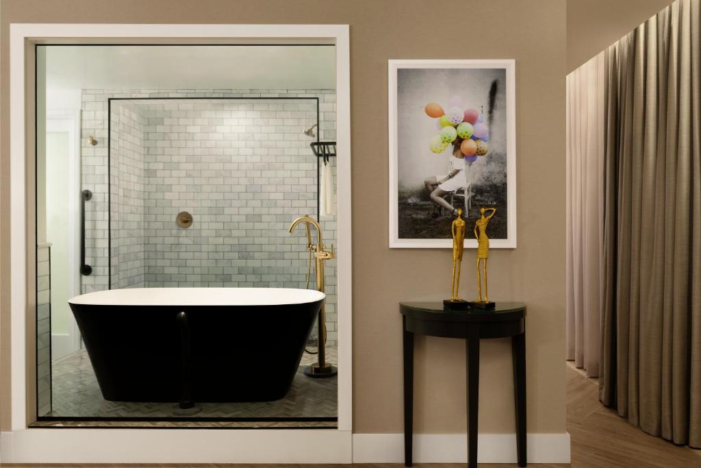a bathroom with a tub and a picture of balloons at EXchange Hotel Vancouver in Vancouver