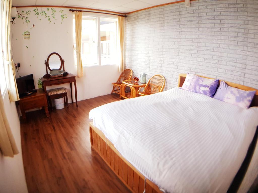 Postel nebo postele na pokoji v ubytování Shan Shui-Yuan Vege Guest House