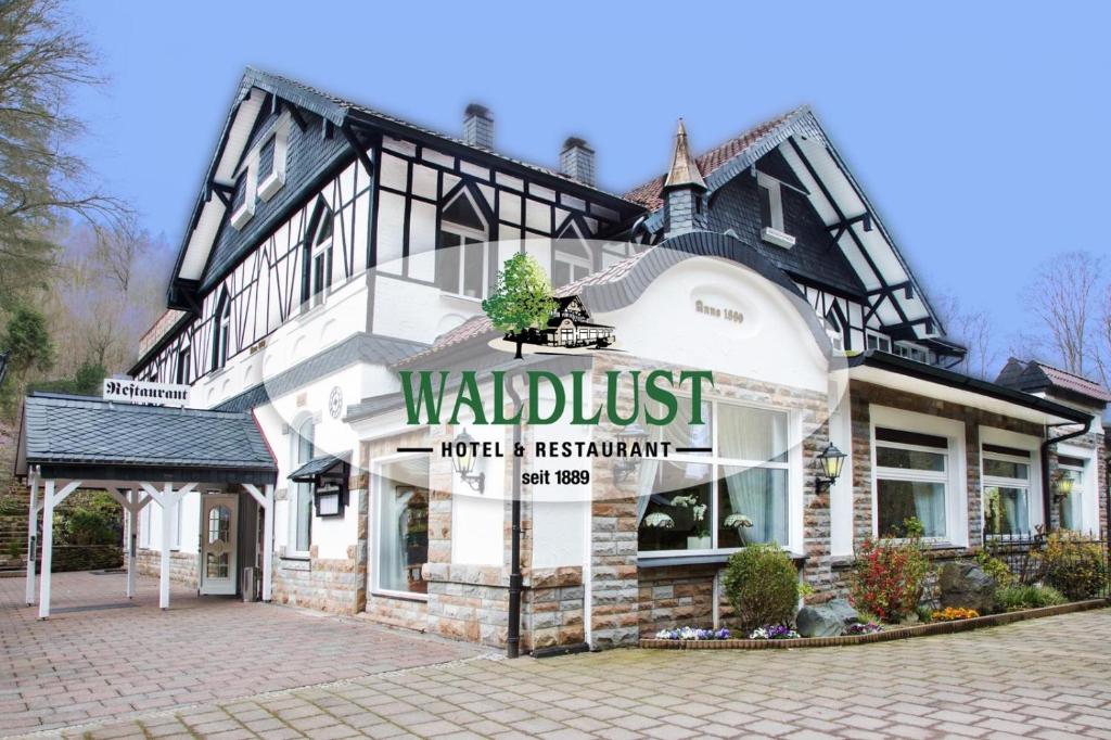 
a large brick building with a sign on the front of it at Hotel Restaurant Waldlust in Hagen
