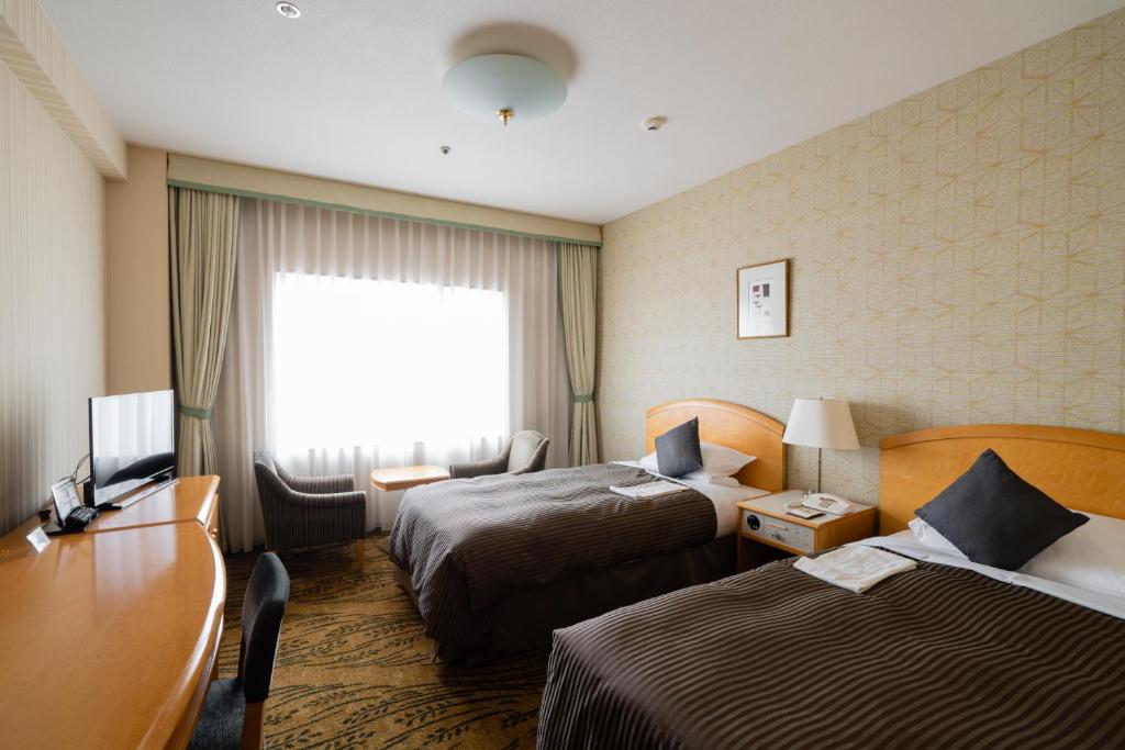 Postel nebo postele na pokoji v ubytování Hotel Okura Niigata