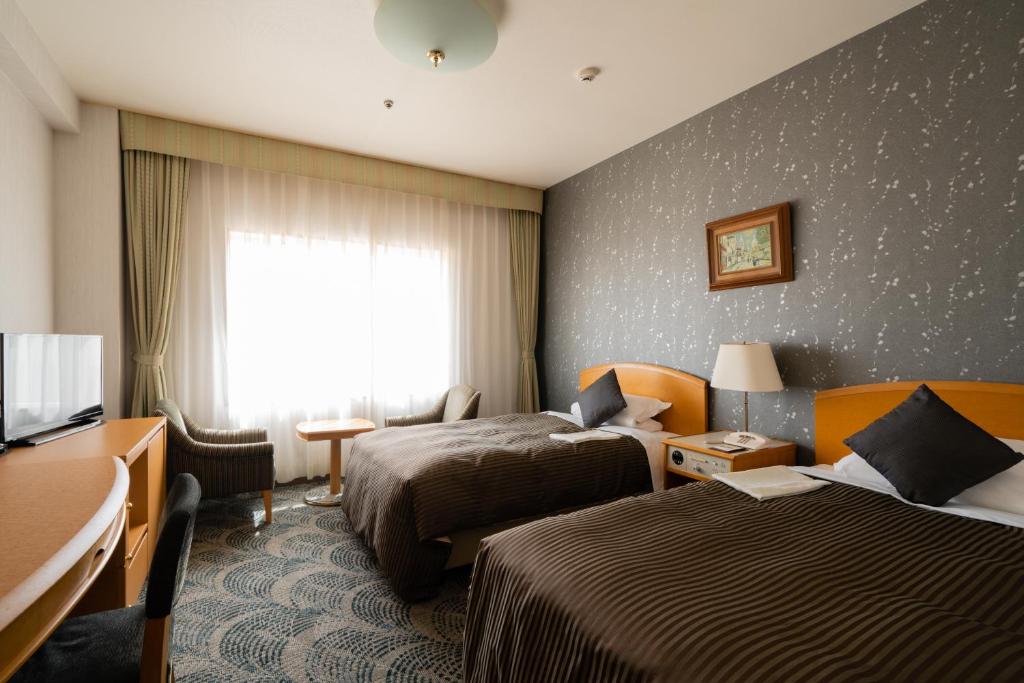 Postel nebo postele na pokoji v ubytování Hotel Okura Niigata