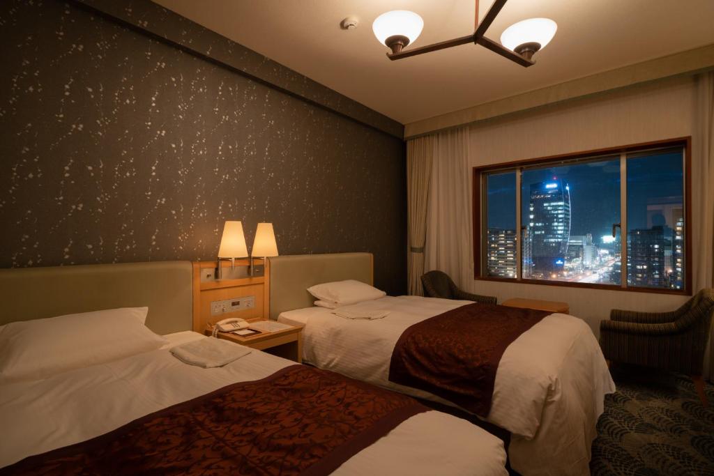 Postel nebo postele na pokoji v ubytování Hotel Okura Niigata