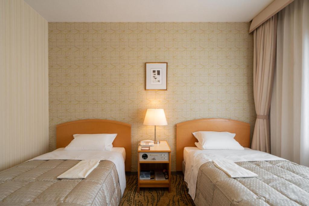 Postel nebo postele na pokoji v ubytování Hotel Okura Niigata