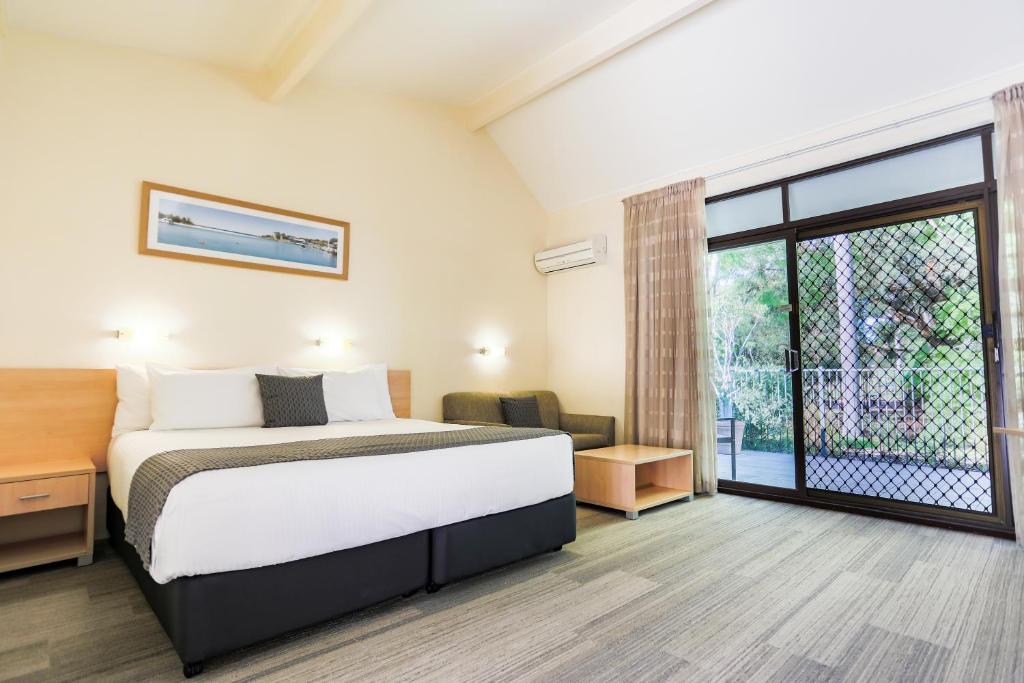 a bedroom with a bed and a large window at Parkhaven in Nowra