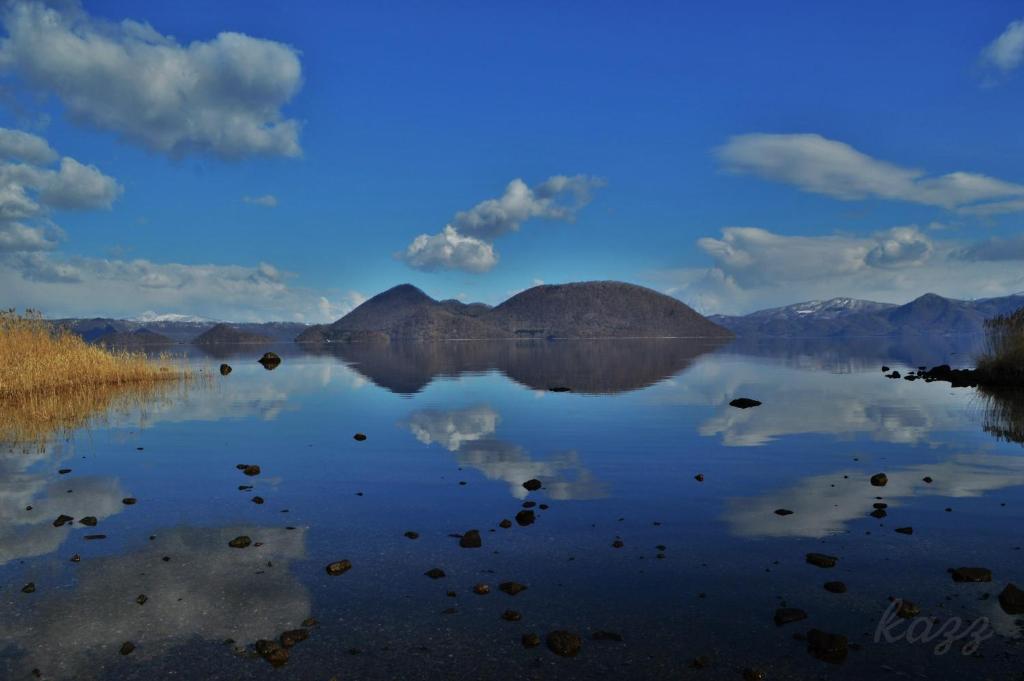 a view of a lake with mountains in the background at TOYA HOME kairou 一棟貸切 in Lake Toya