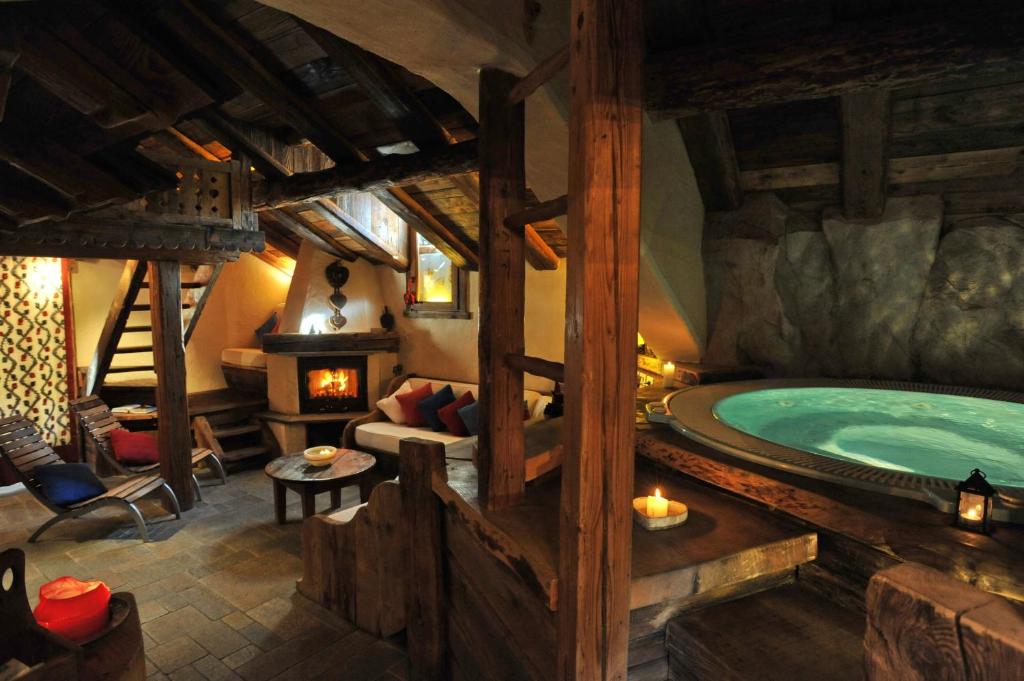 a room with a large tub in a house at Hotel Du Grand Paradis - 1899 Auberge Boutique in Cogne