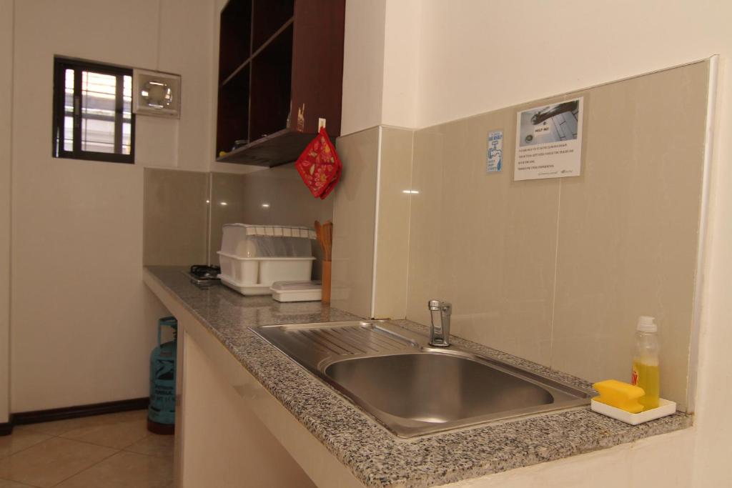 a kitchen with a sink and a counter top at Greenyard Inn in Boracay