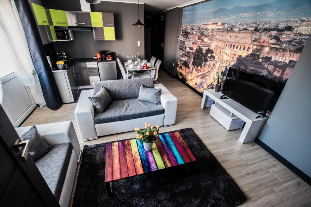a living room with a couch and a tv at Apartments For You in Lębork