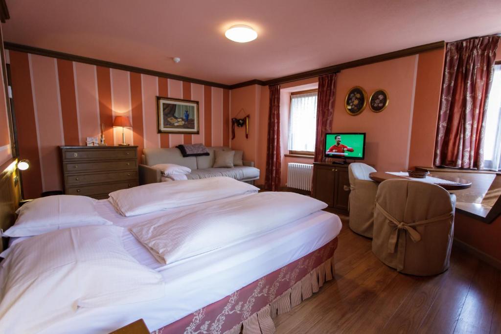 Postel nebo postele na pokoji v ubytování Hotel Compagnoni
