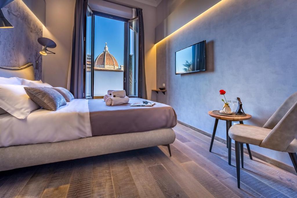 a hotel room with a bed and a window at Palazzo dei Conti Residenza d'Epoca in Florence