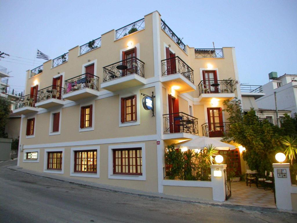 a large white building with windows and balconies at Emily Hotel in Samos
