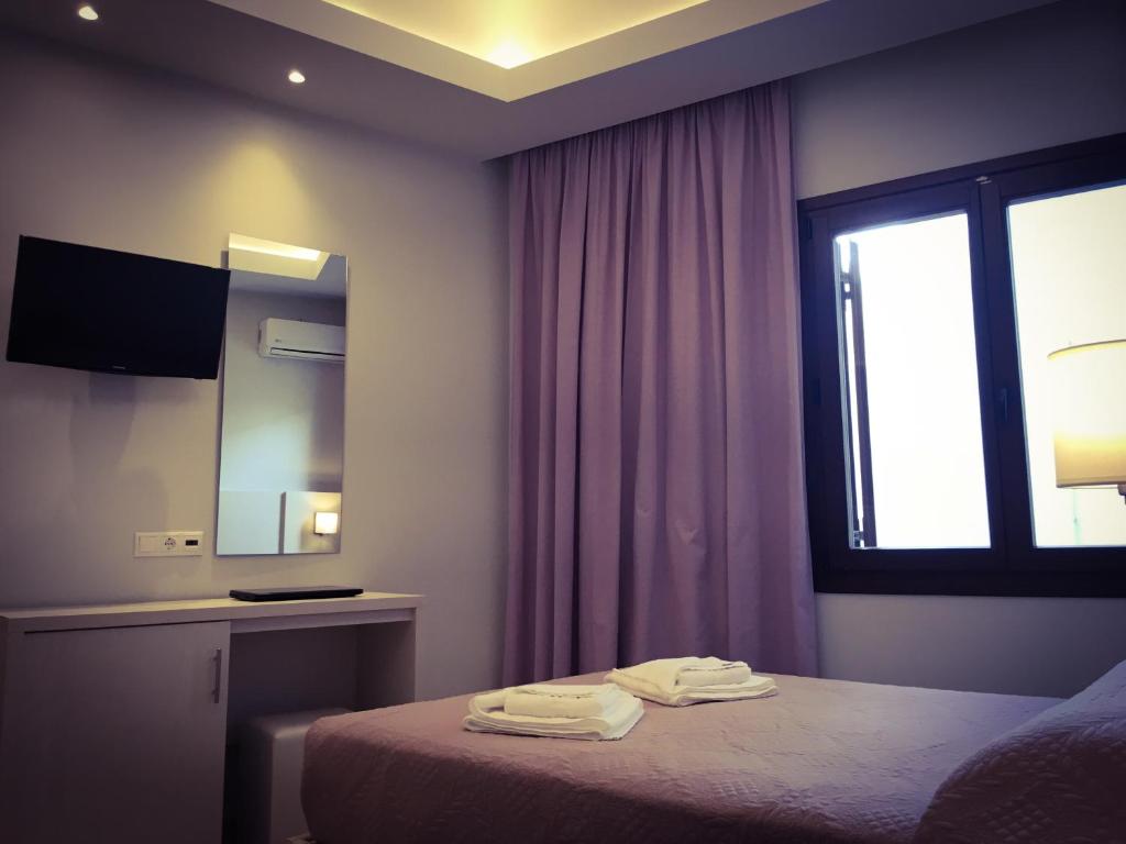 Postel nebo postele na pokoji v ubytování Poseidonio Hotel