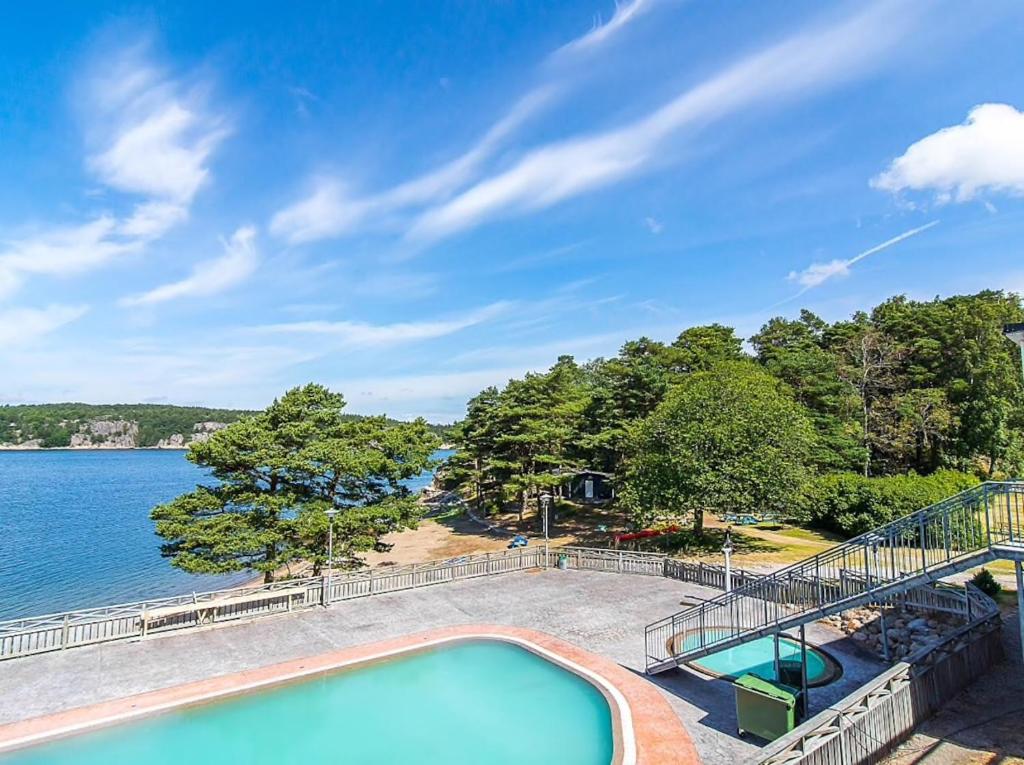 a swimming pool with a view of the water at Hällestrand Apartment 32 in Strömstad