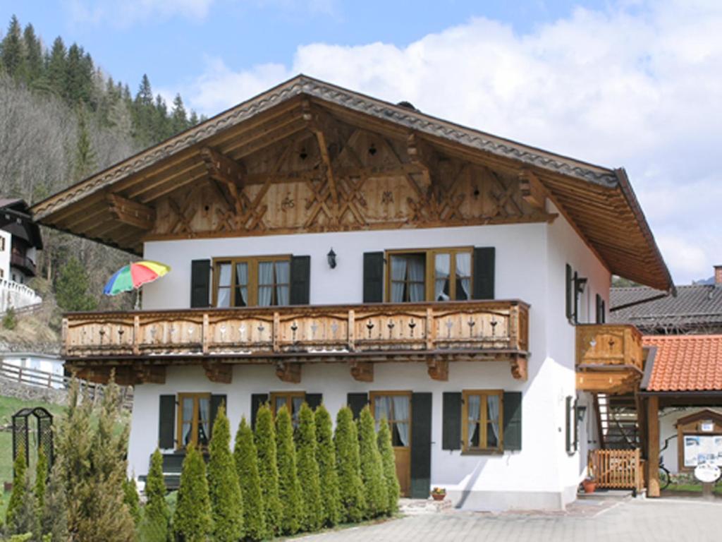 a house with a balcony on top of it at Ferienwohnung 1 Kofler in Mittenwald