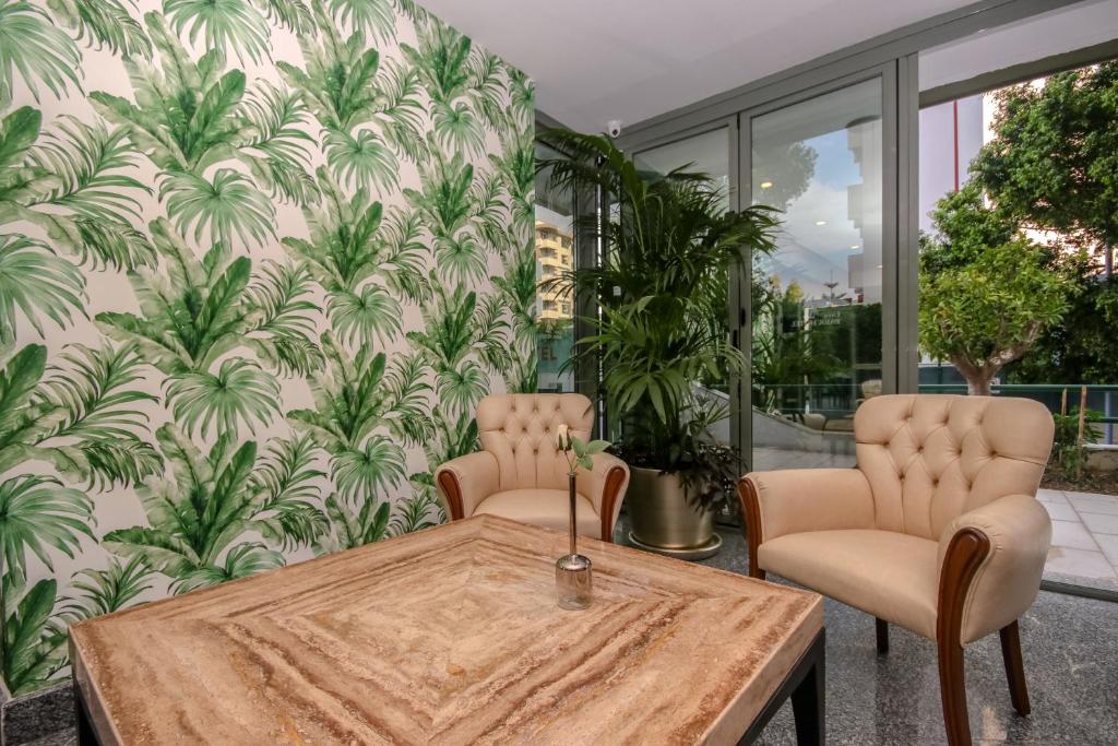 a dining room with a table and two chairs at Lara Park Hotel in Antalya