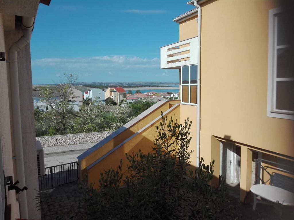 a balcony of a building with a view of the ocean at Apartment Tičić in Povljana