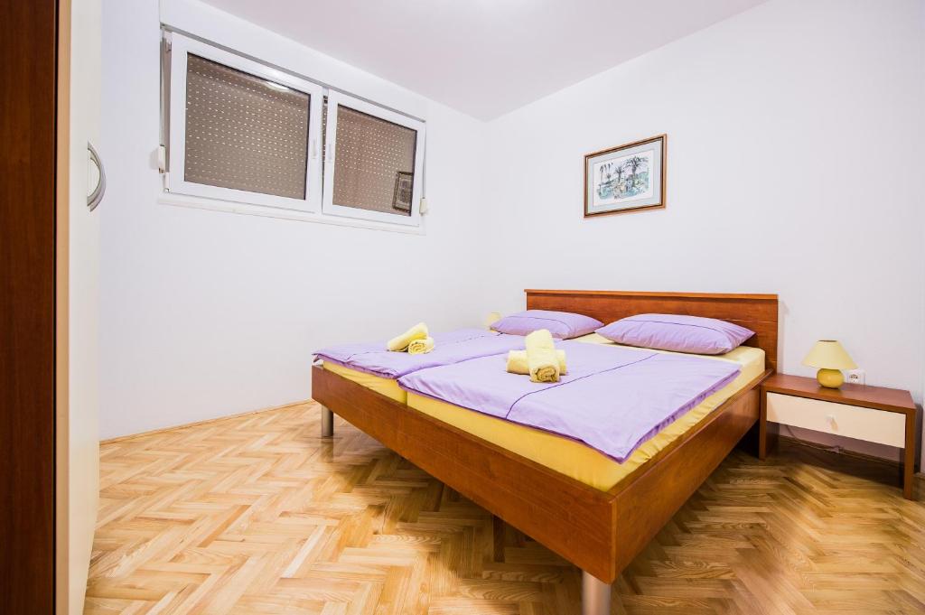 Posteľ alebo postele v izbe v ubytovaní APARTMANI Mila
