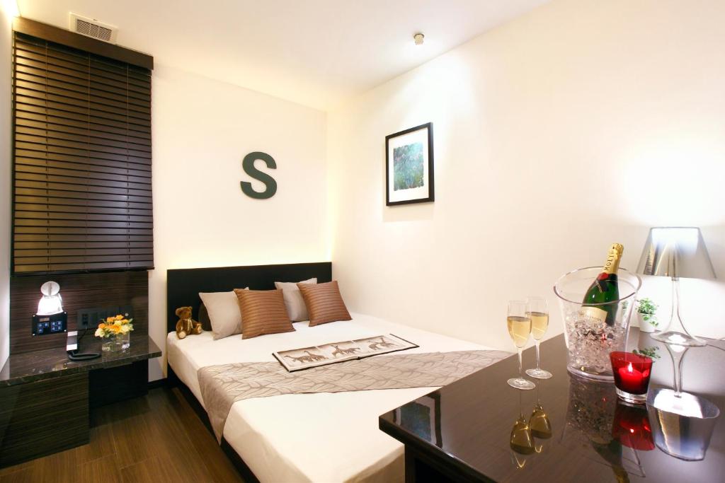 Postel nebo postele na pokoji v ubytování Hotel DUO kinsicho