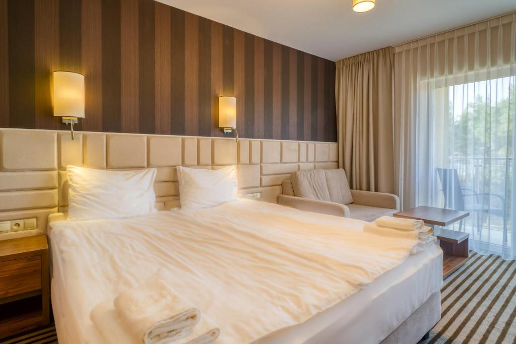 Postel nebo postele na pokoji v ubytování Hotel White