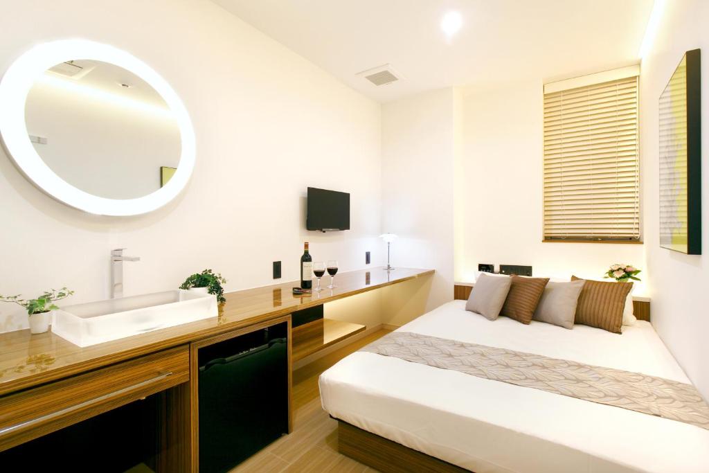Postel nebo postele na pokoji v ubytování Hotel DUO kinsicho