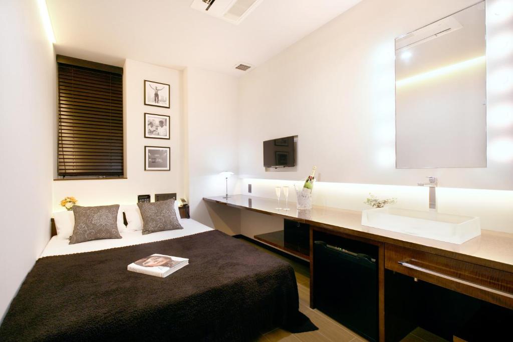 Postel nebo postele na pokoji v ubytování Hotel DUO kinsicho
