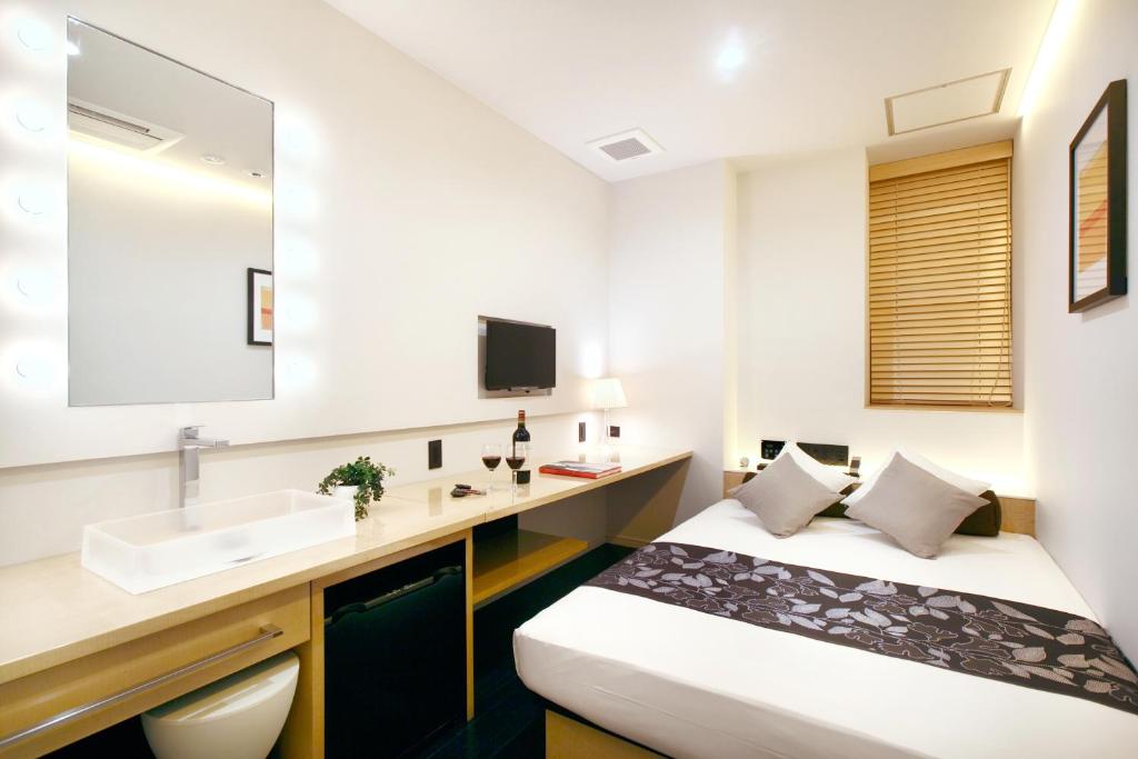 Postel nebo postele na pokoji v ubytování Hotel DUO kinsicho