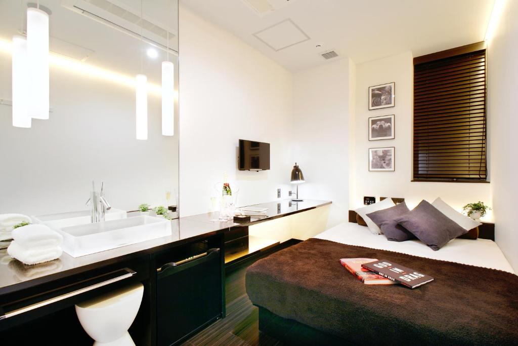 Postel nebo postele na pokoji v ubytování Hotel DUO kinsicho