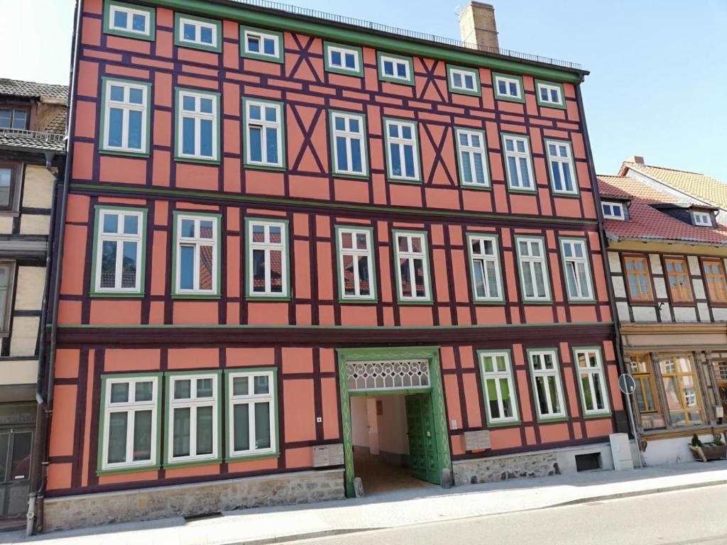 a large red and white building with white windows at Fewo kleine Oase in Wernigerode