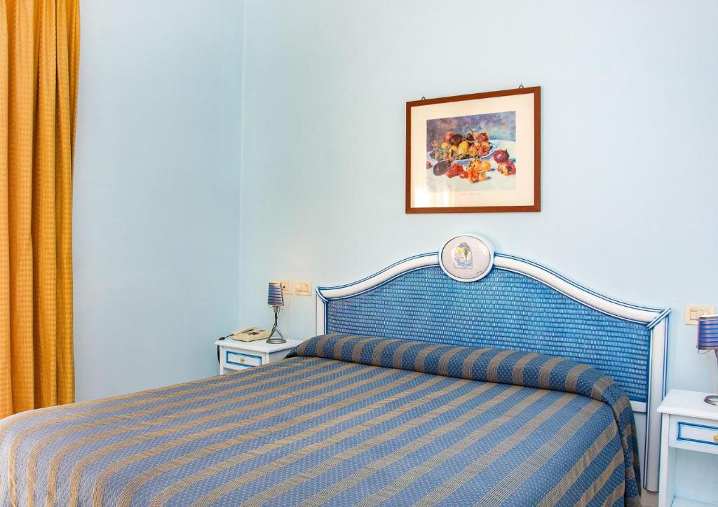 Postel nebo postele na pokoji v ubytování Hotel Gran Paradiso