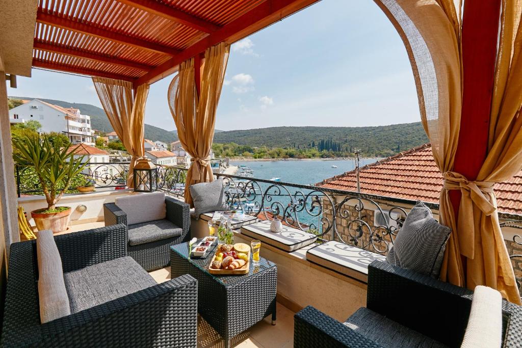 a balcony with chairs and a view of the water at Villa Adria in Kotor