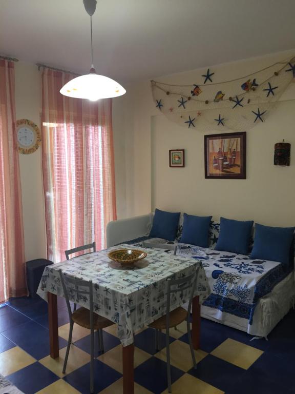 - un salon avec une table et un canapé dans l'établissement SANT'ALESSIO BEACH HOLIDAY, à SantʼAlessio Siculo