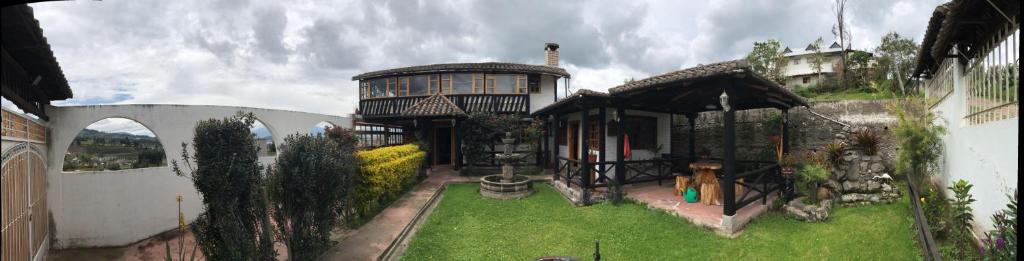 a large house with a garden in front of it at EL DESCANSO “the Rest” in Otavalo