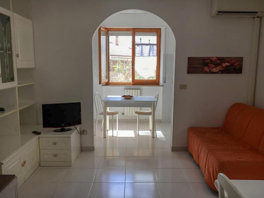 a living room with a table and a couch at La casa di Lory in Falconara Marittima
