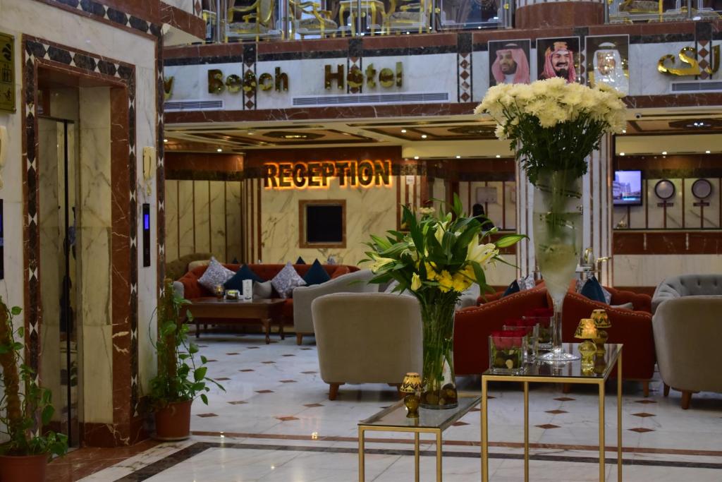 a lobby with couches and flowers on a table at Canary Beach Hotel in Yanbu