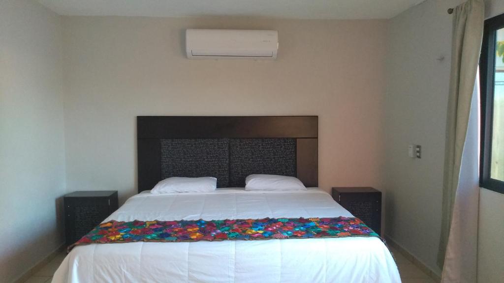 Postel nebo postele na pokoji v ubytování Hotel Kinich Ahau