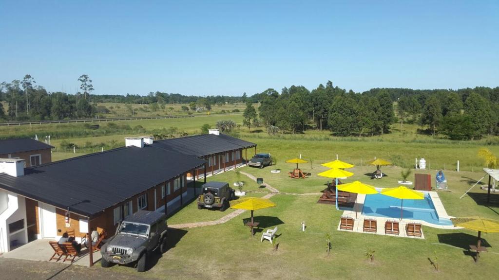 an aerial view of a building with a park with yellow umbrellas at La Celmira in Concordia