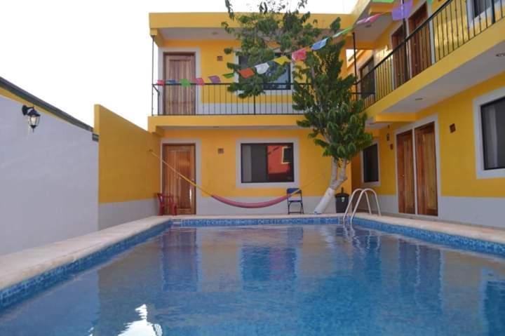 a swimming pool in front of a house at Hotel Kinich Ahau in Valladolid