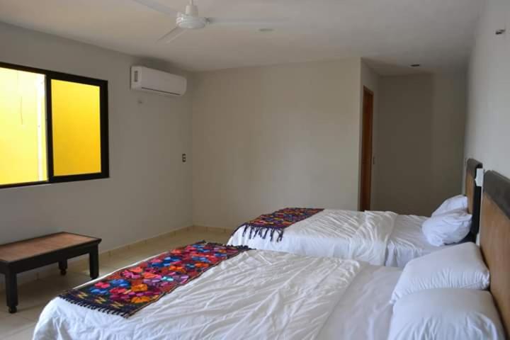 Postel nebo postele na pokoji v ubytování Hotel Kinich Ahau